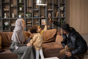 happy diverse family having fun near couch at home
