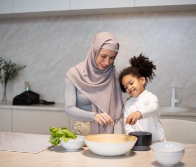 happy diverse mother and daughter cooking together