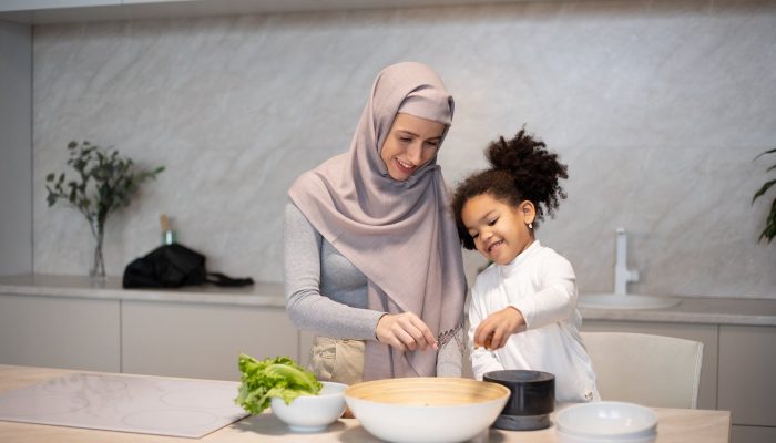 happy diverse mother and daughter cooking together