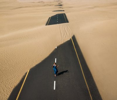 bird s eye view photography of road in the middle of desert