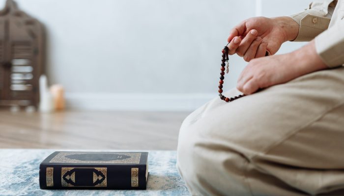 close up shot of person holding prayer beads