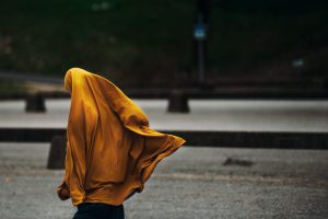 person covered with yellow blanket