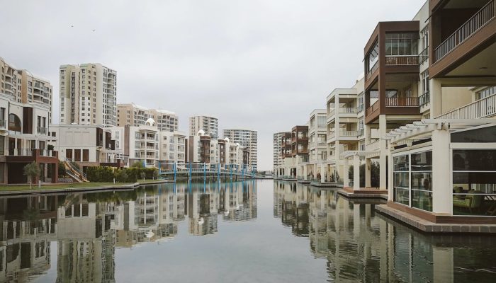 modern residential buildings reflecting in canal