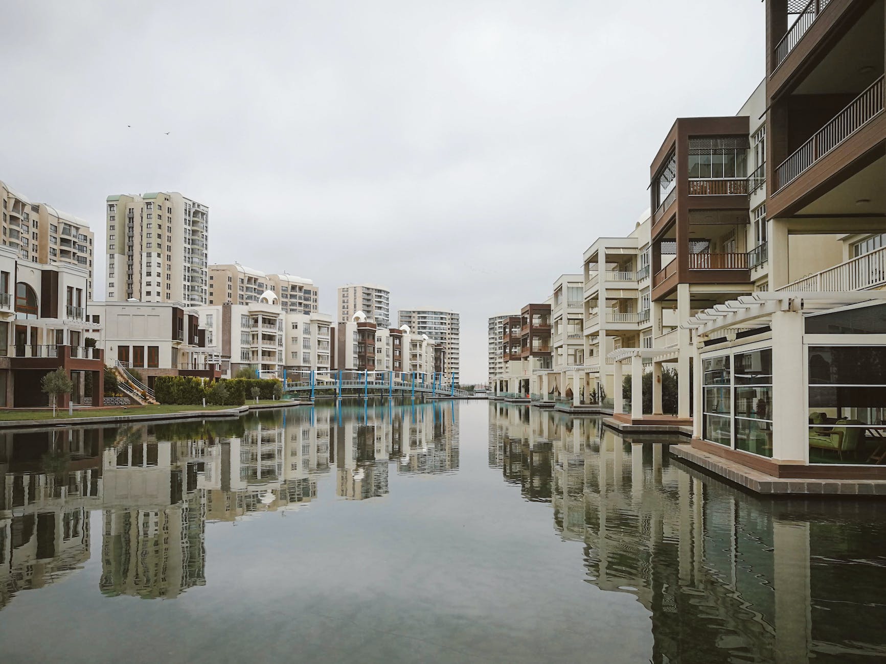 modern residential buildings reflecting in canal