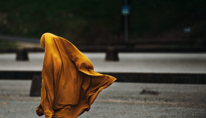 person covered with yellow blanket