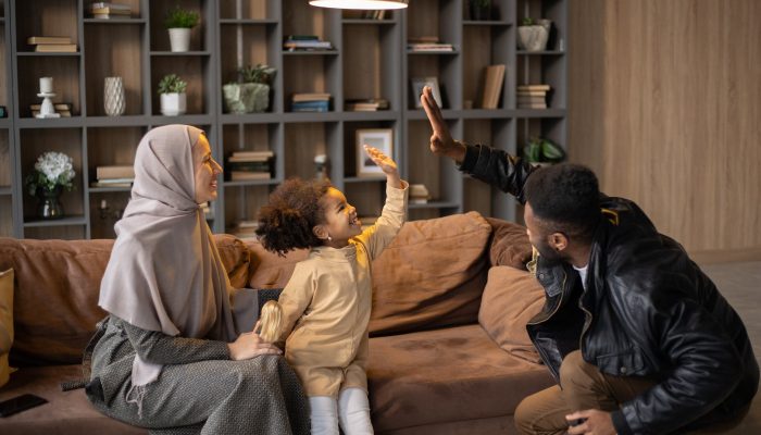 happy diverse family having fun near couch at home
