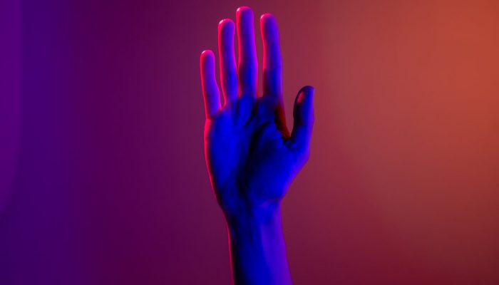 persons left hand with purple manicure