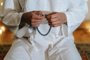 person in white thobe praying