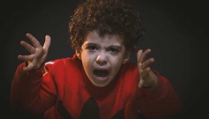 toddler with red adidas sweat shirt