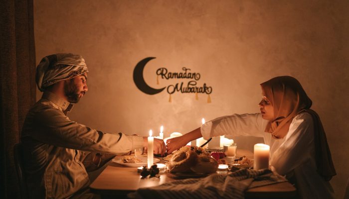 a couple having dinner with lighted candles