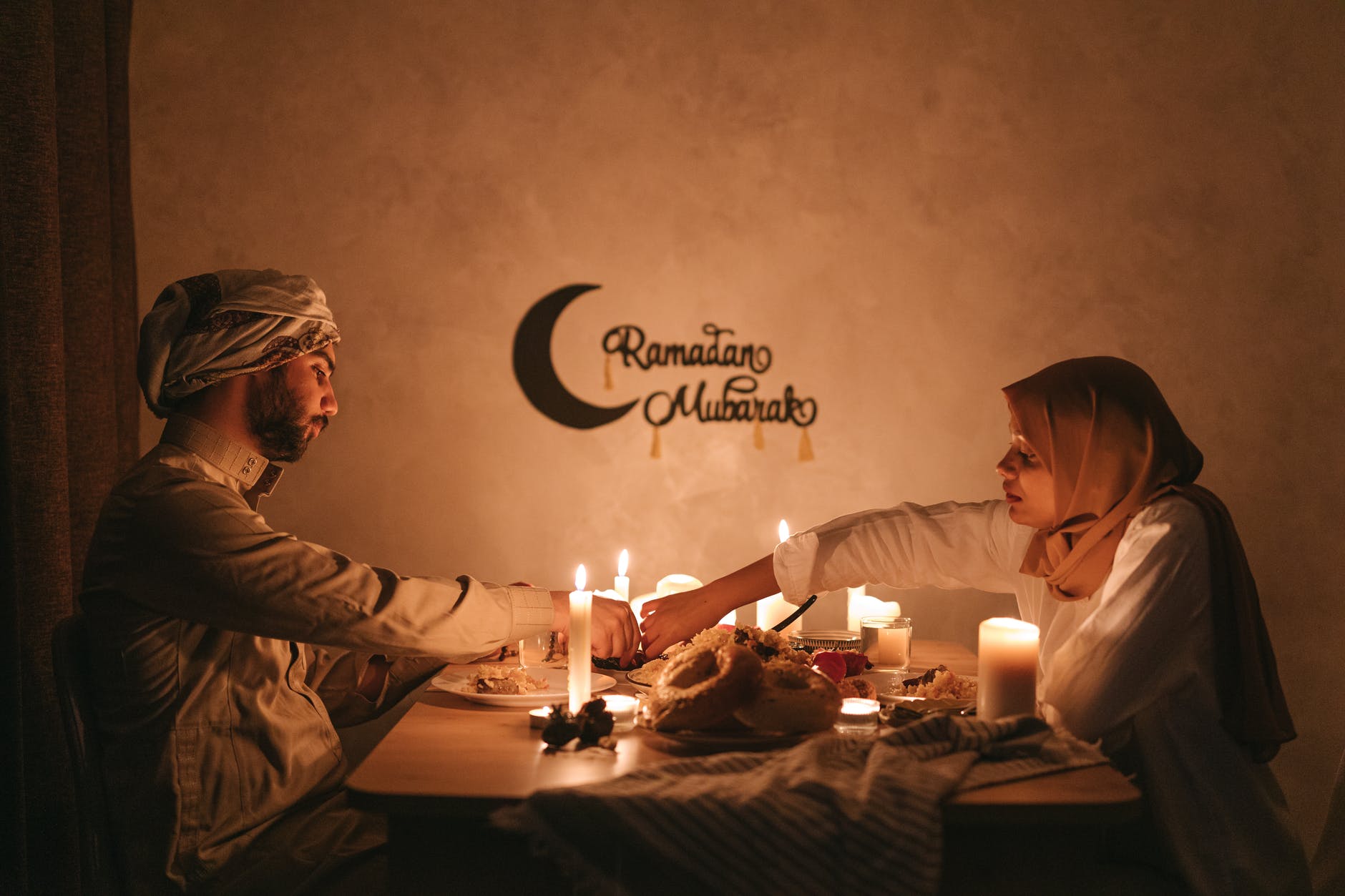 a couple having dinner with lighted candles