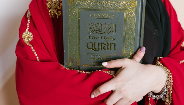 person holding a holy quran book