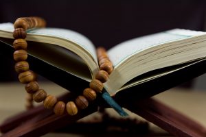 close up shot of prayer beads on a book