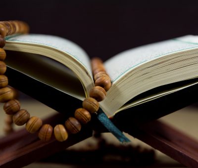 close up shot of prayer beads on a book