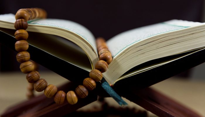 close up shot of prayer beads on a book