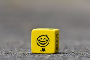 yellow cube on brown pavement