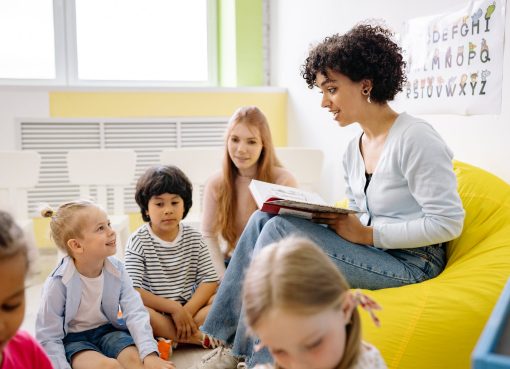 woman reading a book to the children