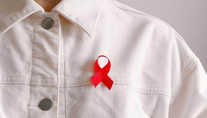 man wearing red ribbon